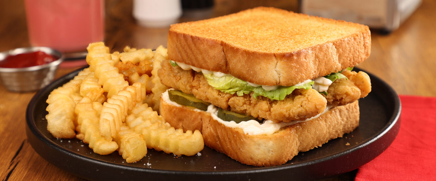 A chicken sandwich with fries